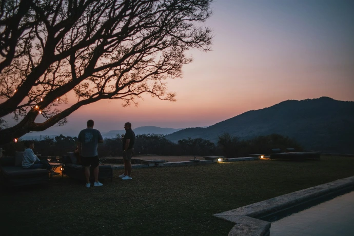 a couple of people that are standing in the grass